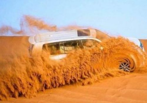 dubai-desert-safari-adventure.jpg Luxury SUV driving through Dubai desert dunes on thrilling safari adventure